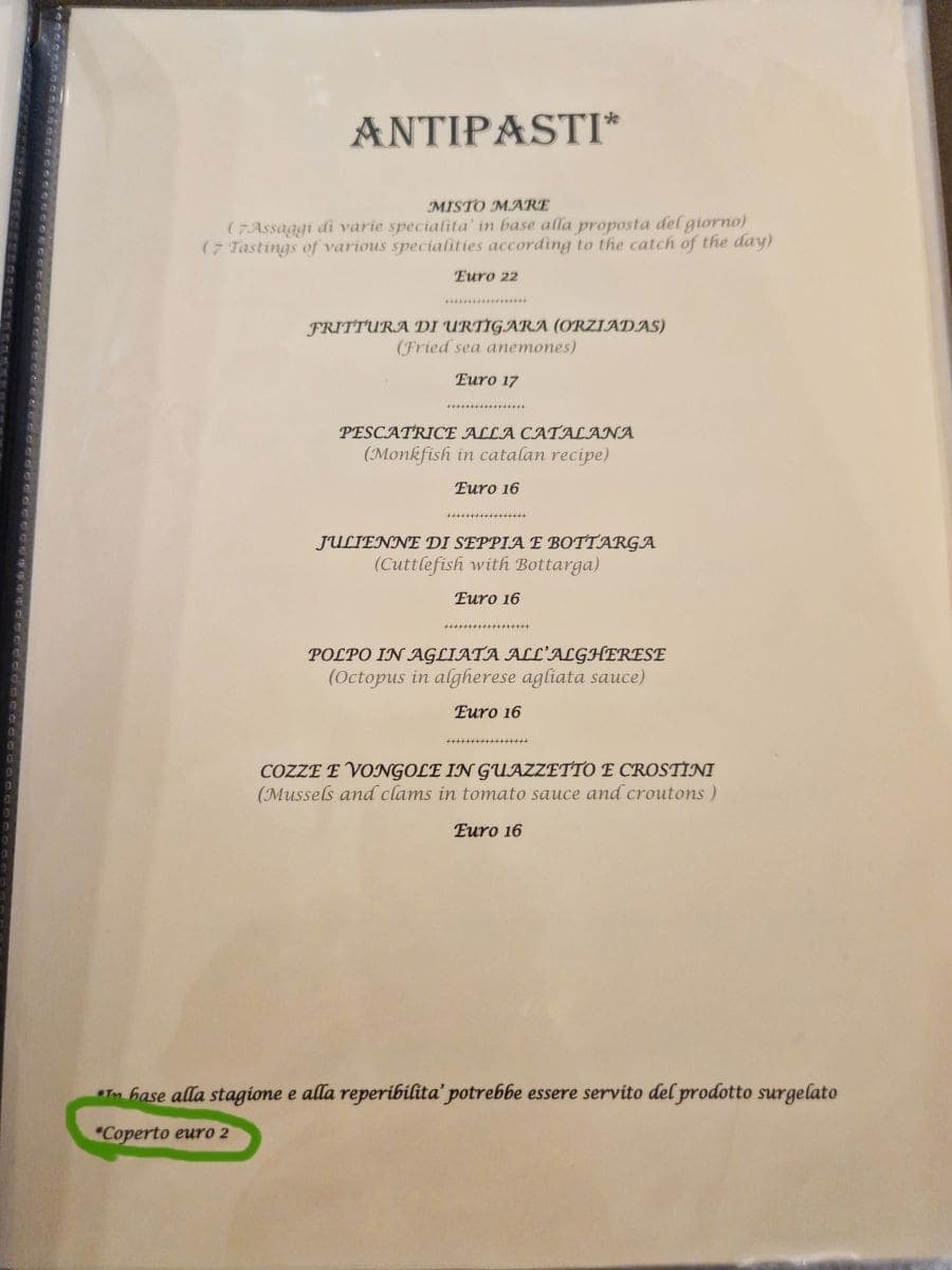 a menu of antipasti in a restaurant in italy with coperto euro 2 higlighted - tipping in Italy is often kind of substituted with coperto