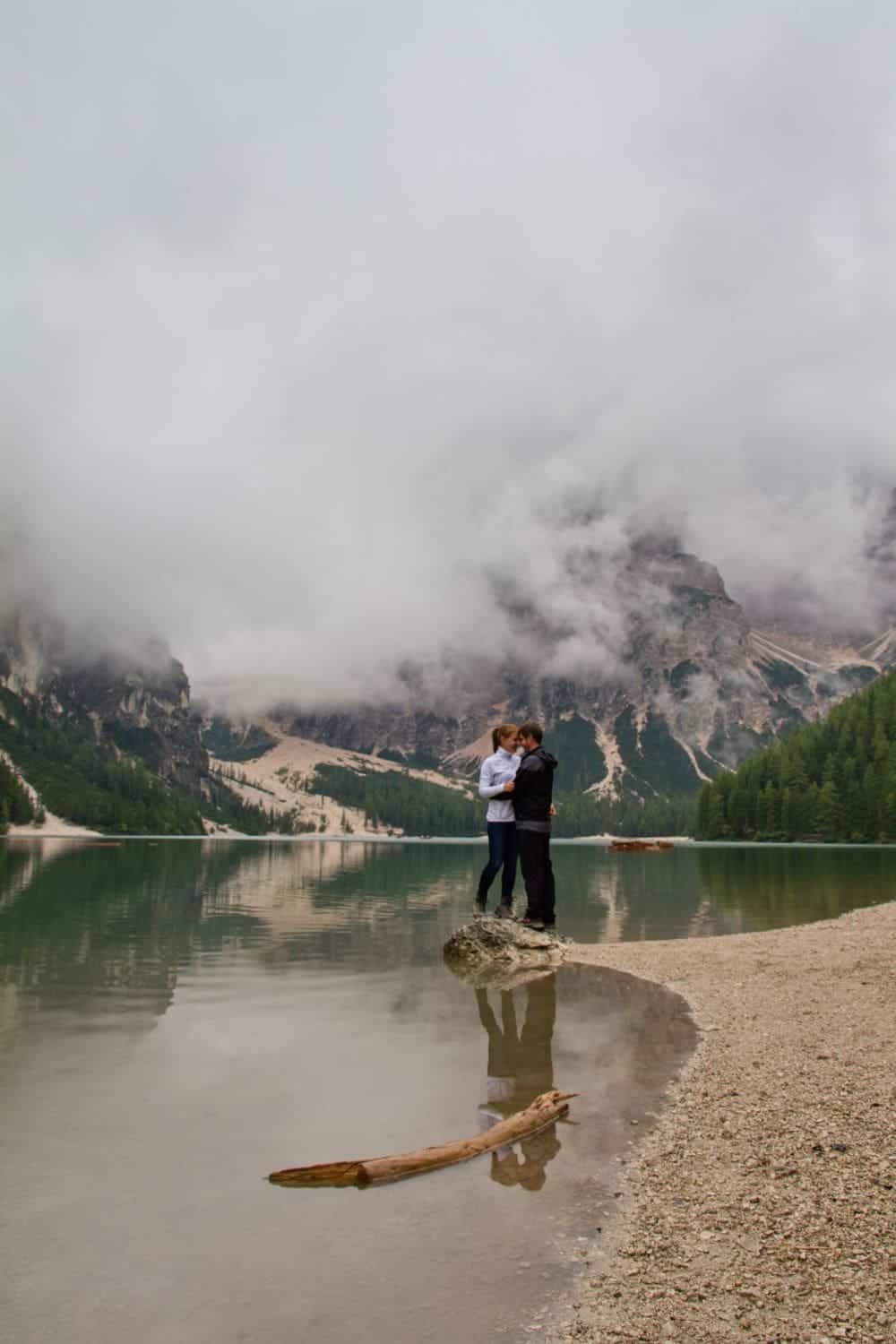 Lago di Braies: Discover The Pearl of the Dolomites 17 kristine and michal at lake braies in the dolomites with a cloud covering the mountains in the background