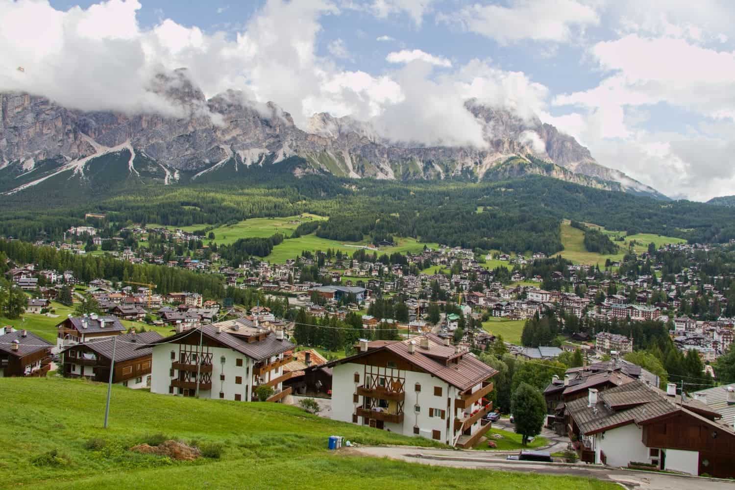 view of cortina d'ampezzo town in the dolomites with cloudy mountains in the background