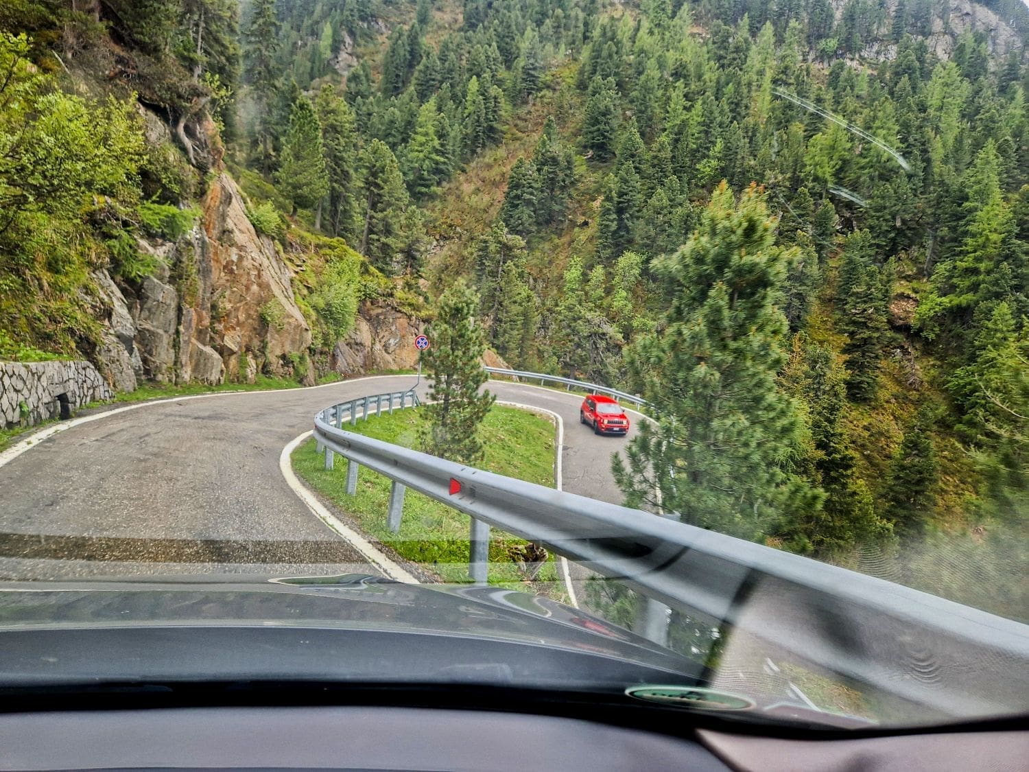 driving on a narrow single lane road in a hairpin bend from stella pass to the dolomites