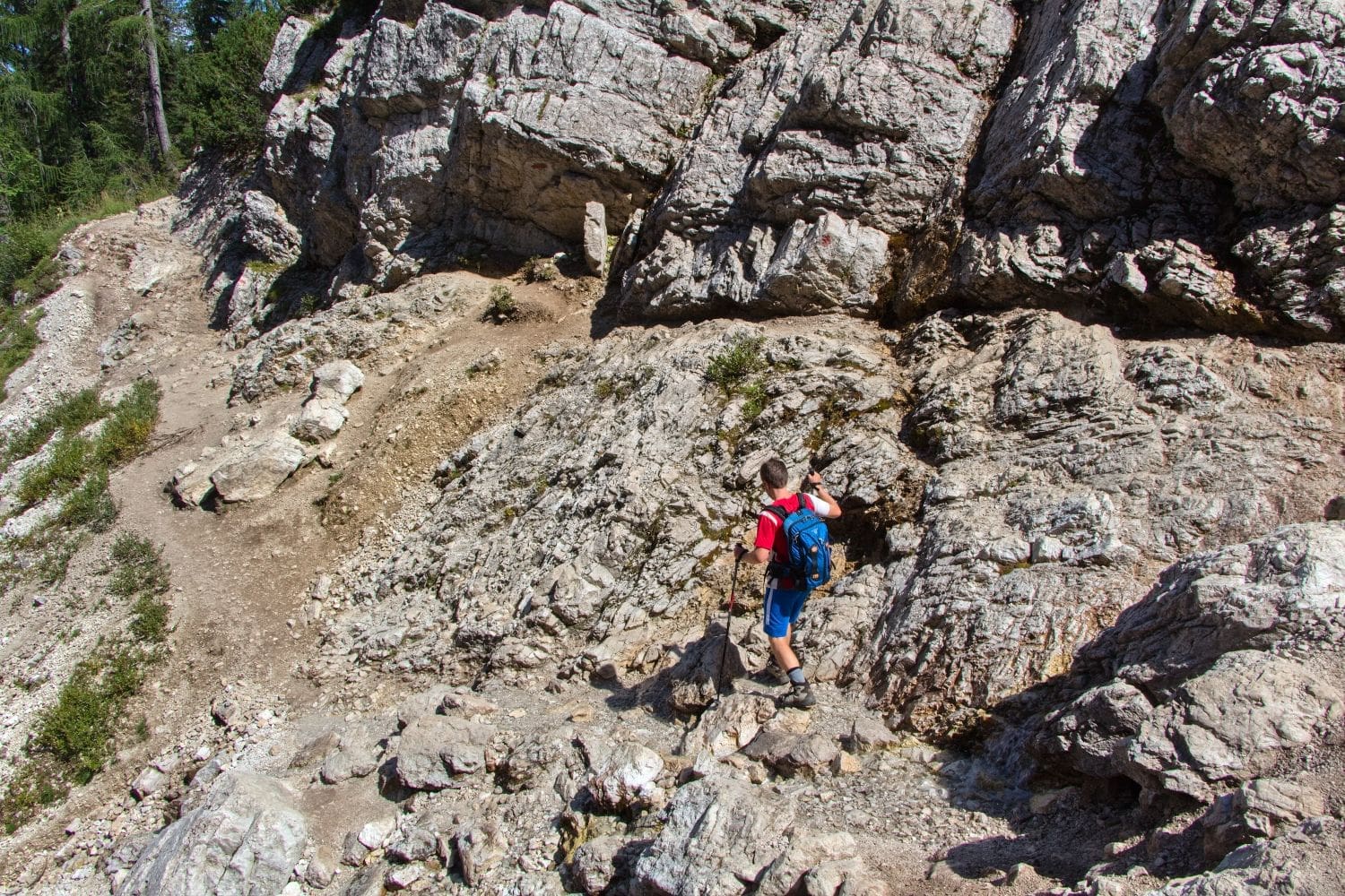 Michal hiking on rocks during the lago di sorapis hike in the dolomites in summer