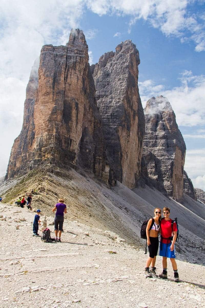michal and Kristine in hiking clothes with the tre cime di lavaredo in the background dolomites