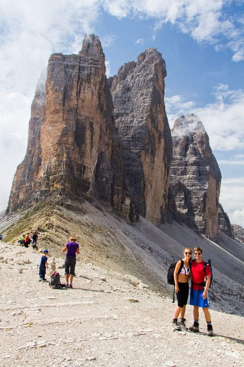 michal and Kristine in hiking clothes with the tre cime di lavaredo in the background dolomites