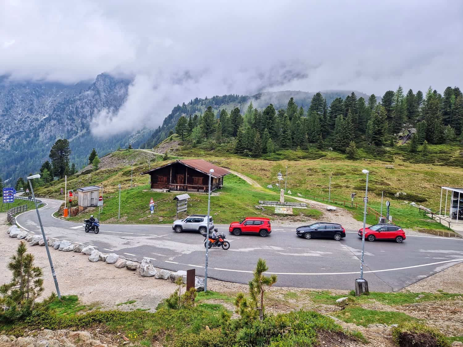 four cars and two motorcycles in a traffic jam at passo stella on the italy austria border