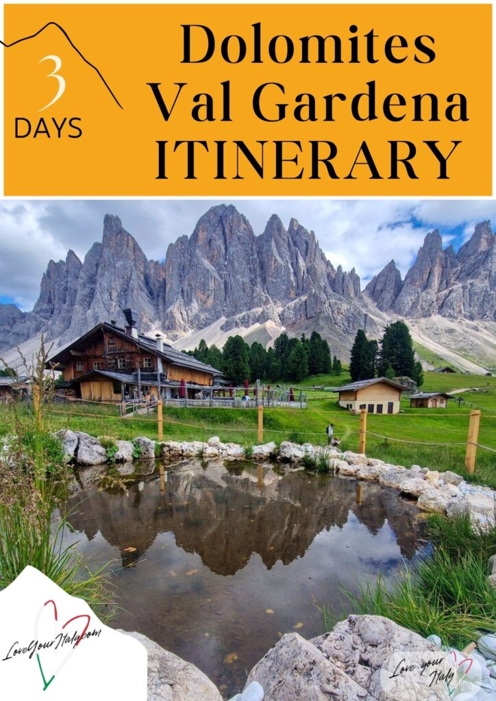 graphic that reads 3 Days Dolomites Val Gardena Itinerary in bold black text on a mustard yellow background above a scenic alpine landscape. A rustic wooden cabin and small outbuildings sit in a green meadow with a reflective pond in the foreground and the dramatic jagged peaks of Val Gardena rising behind them under a cloudy sky, with Love Your Italy logos in the corners.